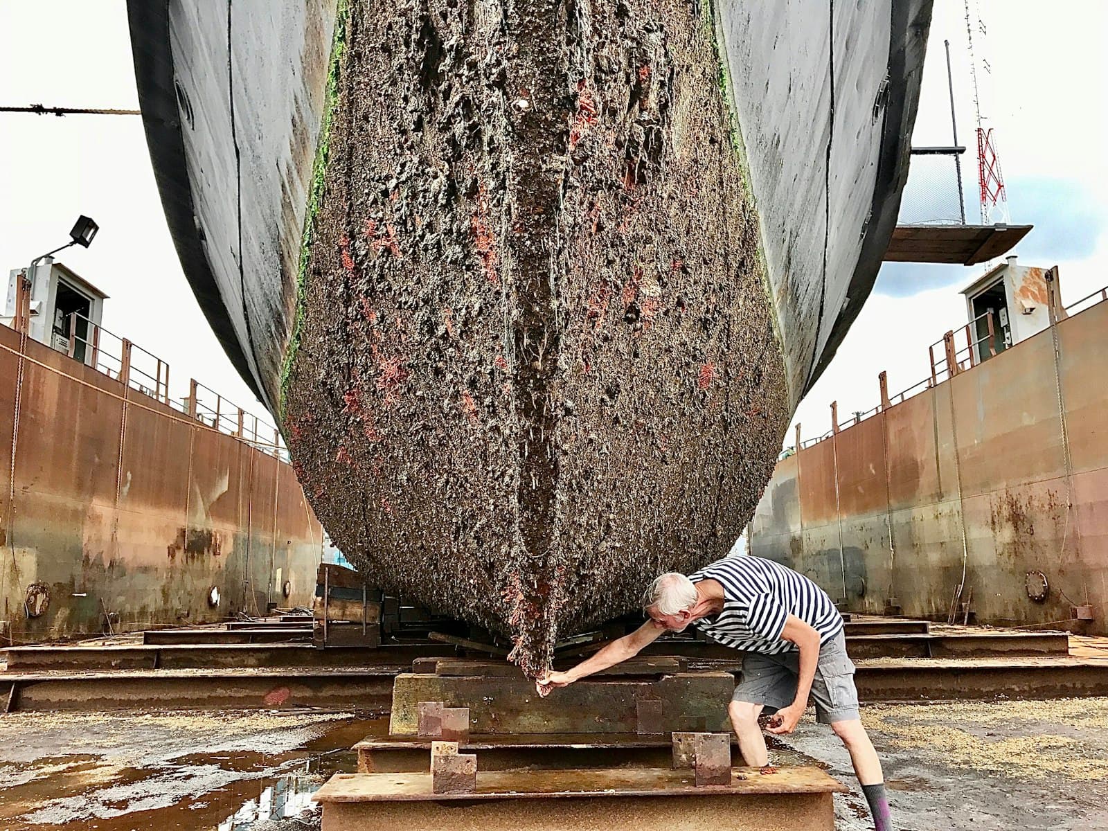 Man working on a boat hull in dry dock
