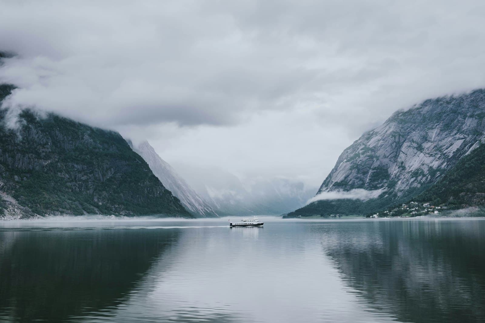 Boat cruising through a Norwegian fjord